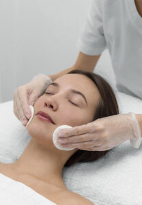 beautician with female client at salon for face care routine 208x300 1