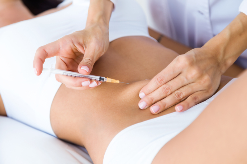 surgeon making injection into female body liposuction concept (1)
